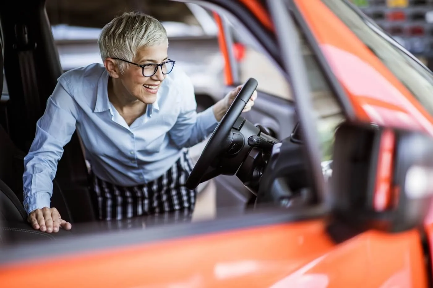 Woman getting into the orange car