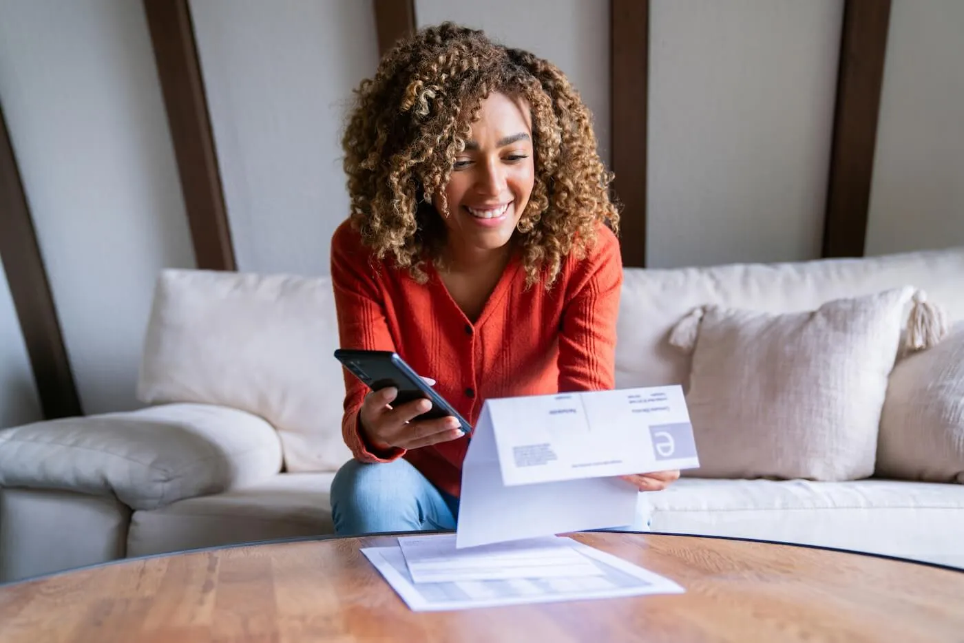 Smiling woman paying utility bills at home