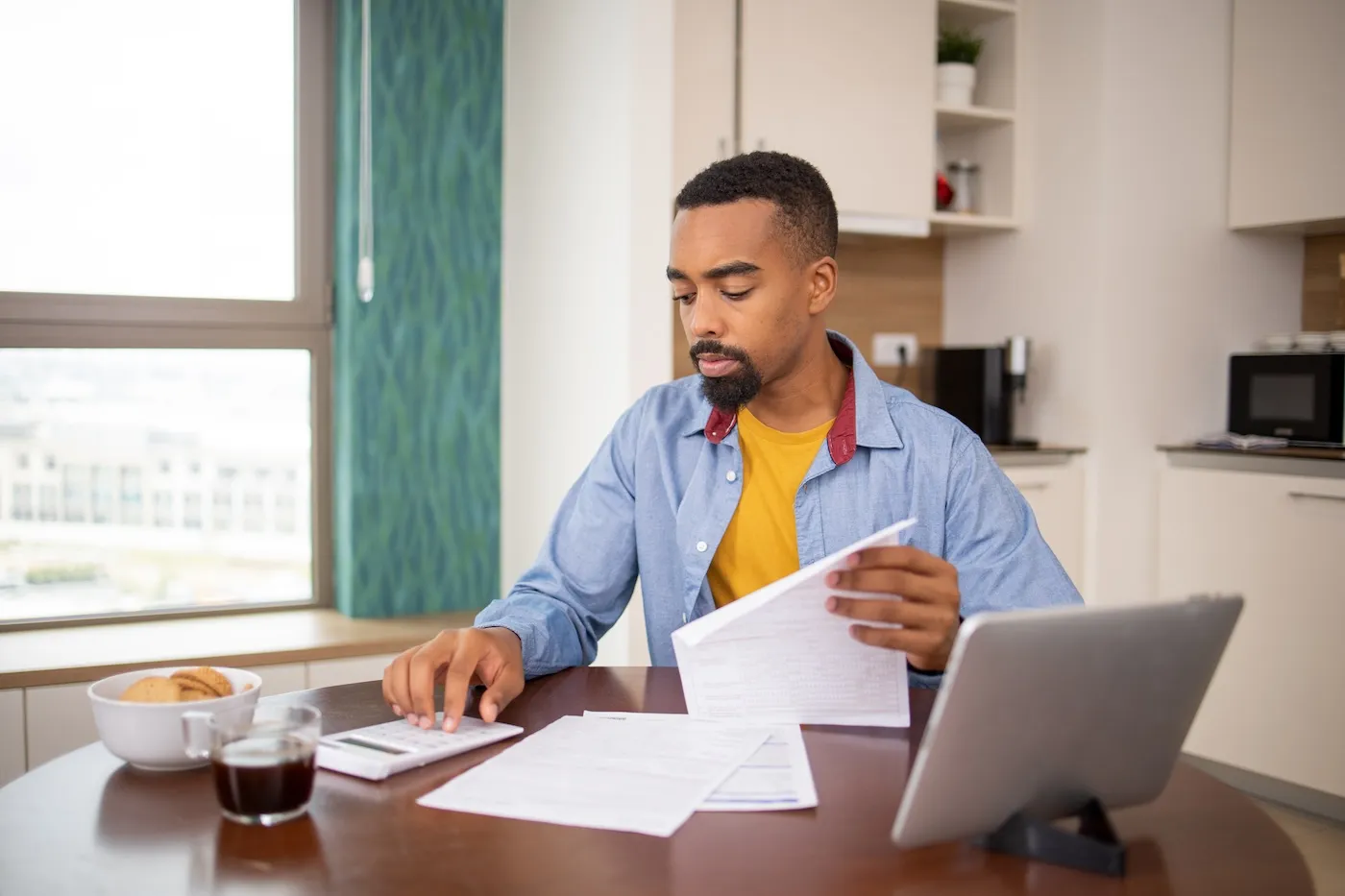 Young man is going through bills and finances