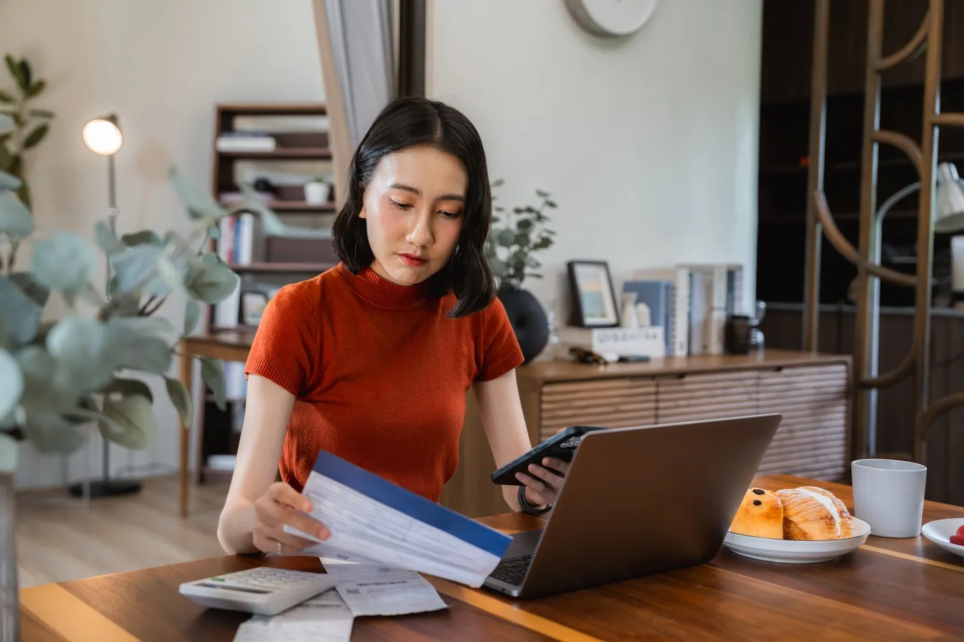 A woman doing personal work on her laptop at home.