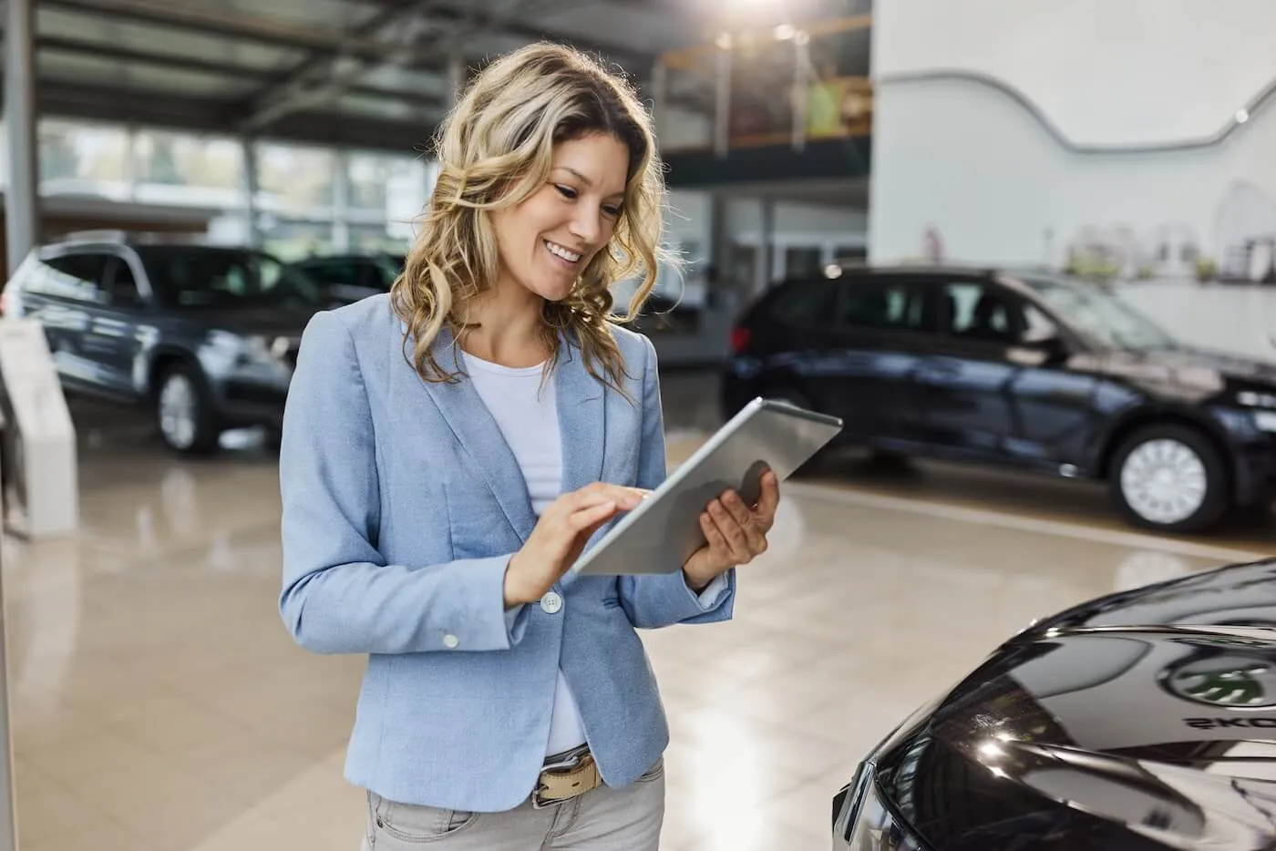 Woman checking car loan interest rates on the tablet