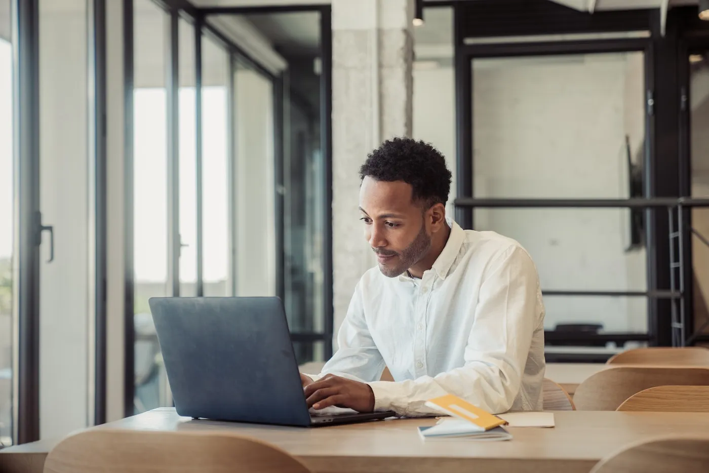 A young man using his laptop while working in his office