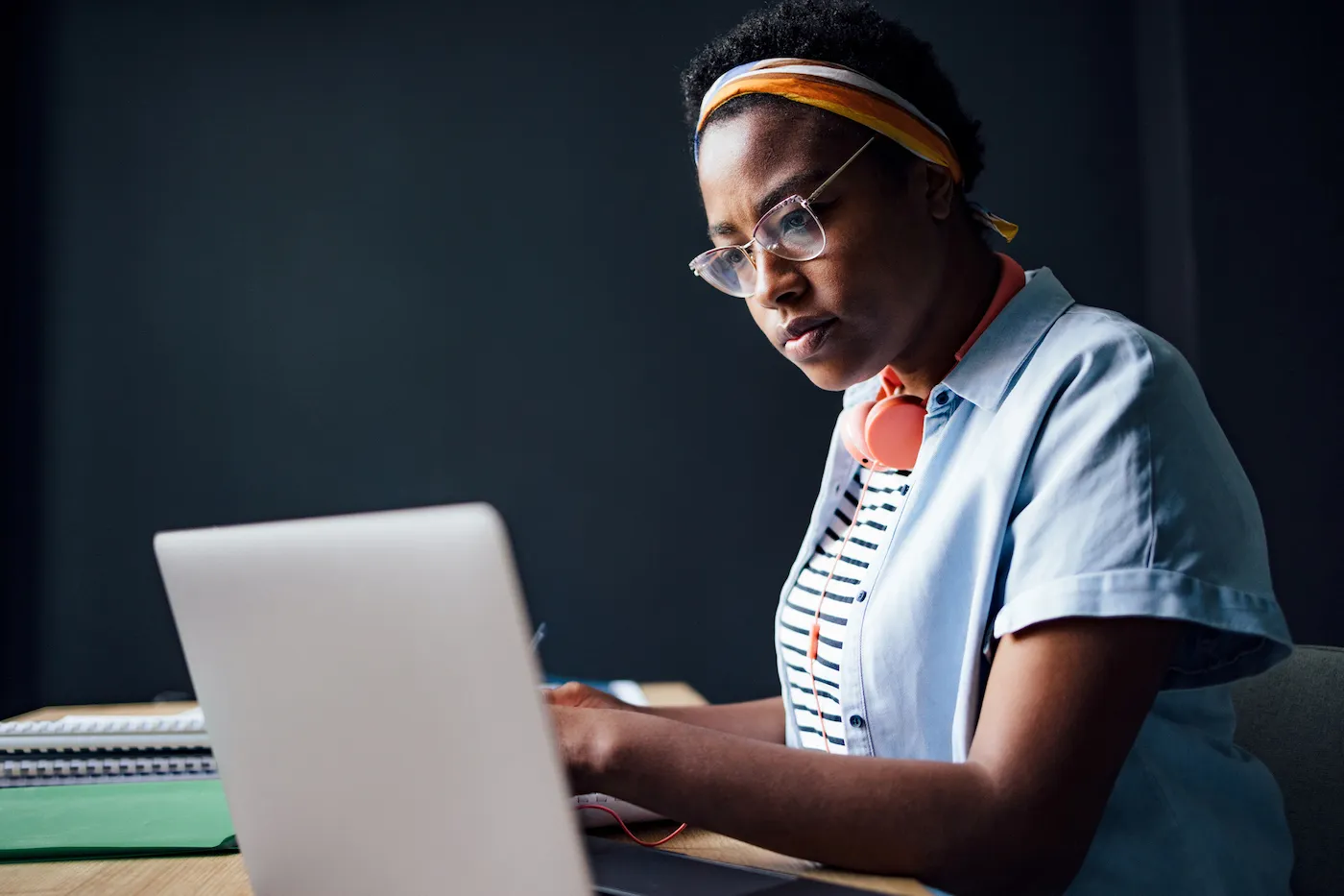 Serious woman using a laptop computer while sitting at desk