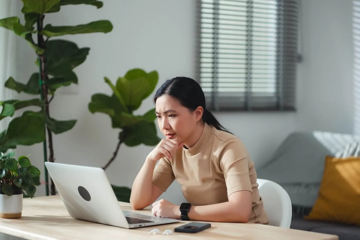 Focused woman working on a laptop