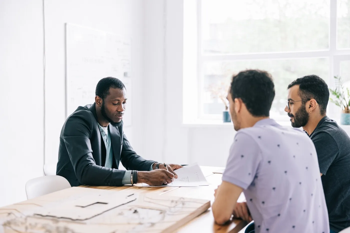 A real estate agent presenting a new future project to a couple with various scenarios.