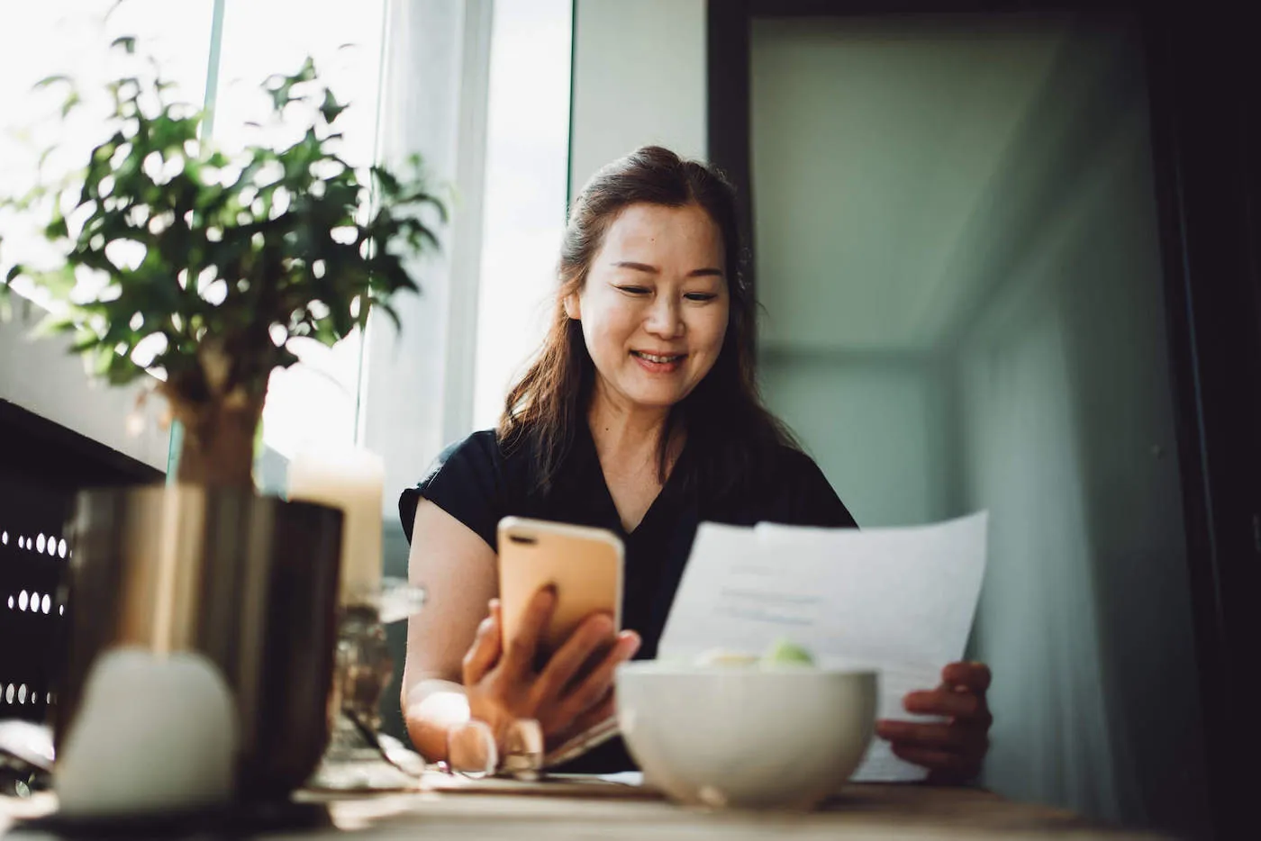 Woman finalizing holiday budget on mobile device.