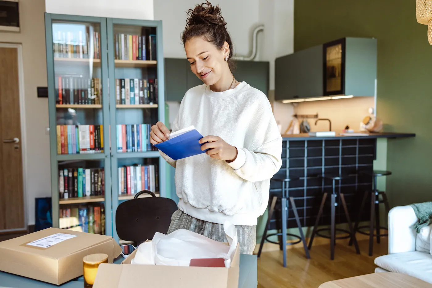 Woman reading mail that her application was preapproved