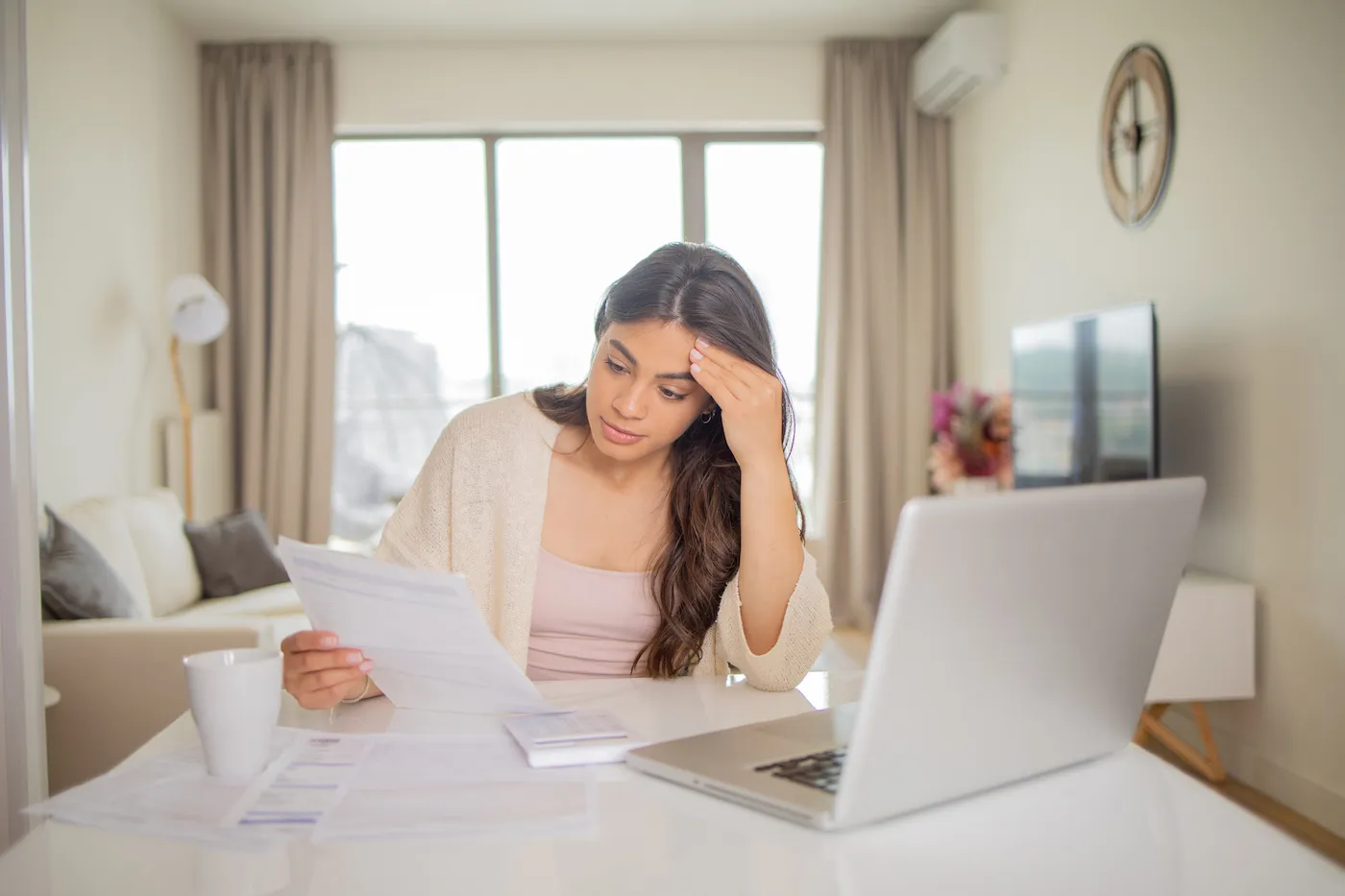 Young woman paying student loan bills