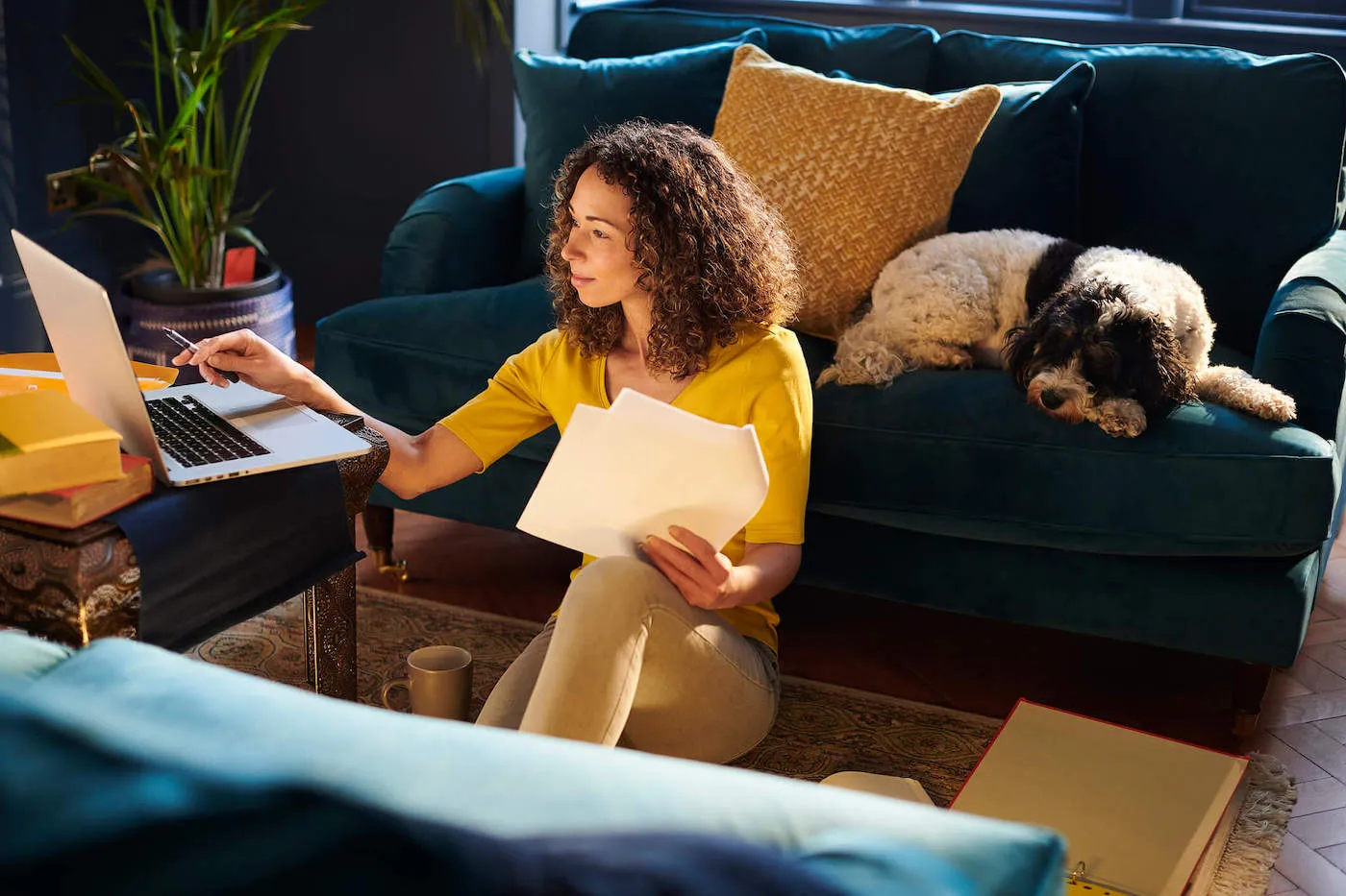 Woman seated on the floor researching insurances.