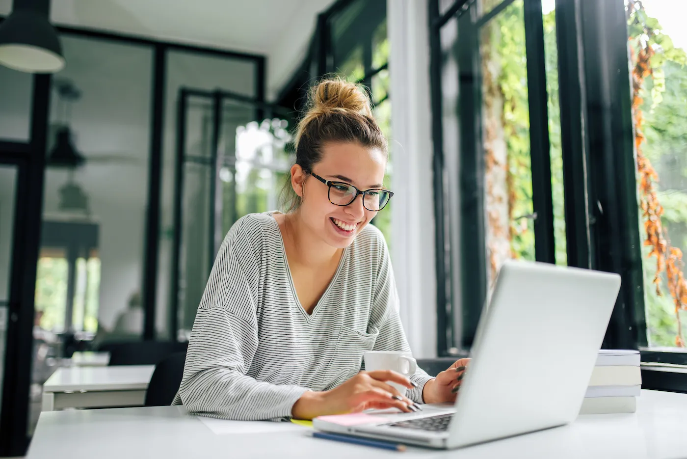 A woman using a laptop to choose loan terms.