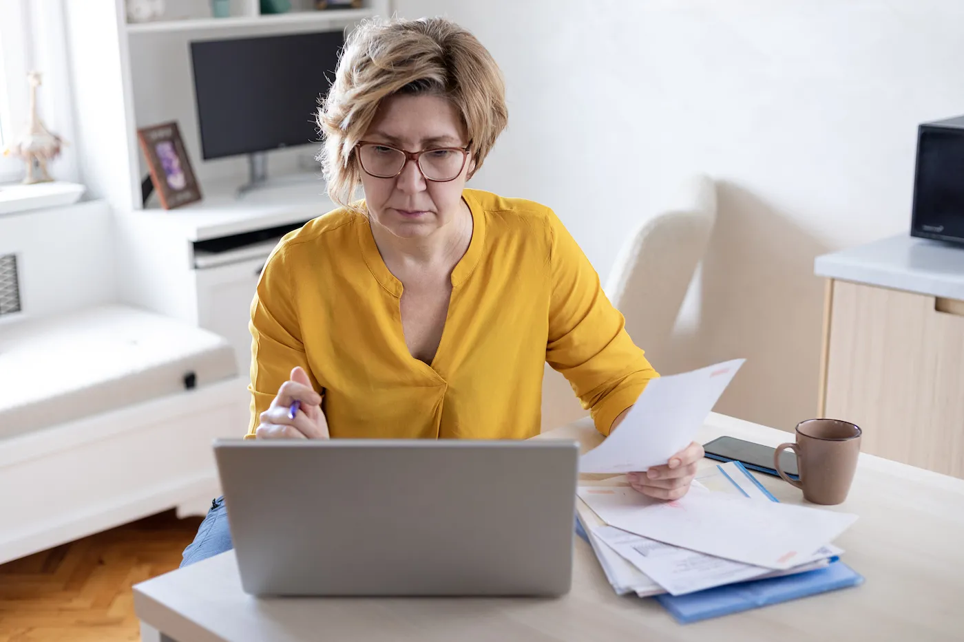 A woman doing her finances, learning about early CD withdrawal penalty