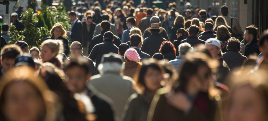 People walking down a busy sidewalk