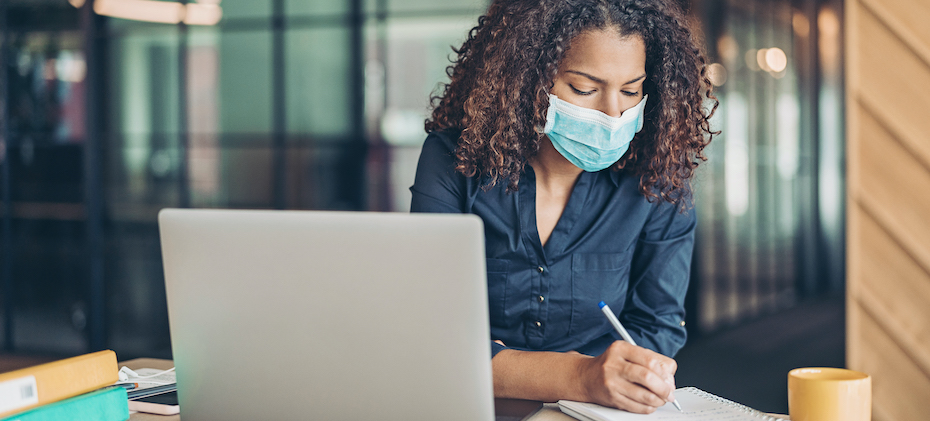 Businesswoman working wearing a protective mask