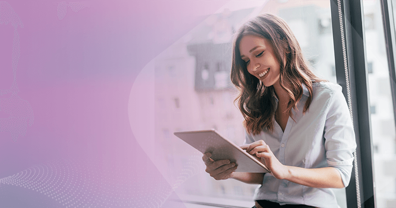 Woman smiling holding tablet in office