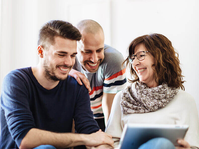 Three people looking at tablet