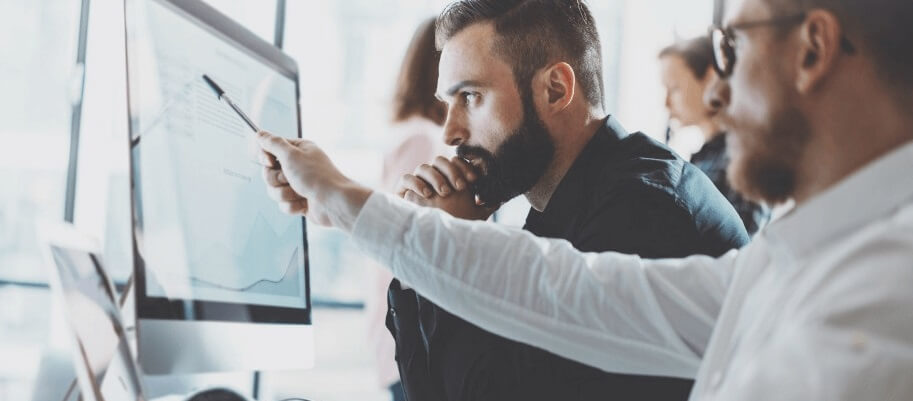 man-looking-computer-screen-pointing